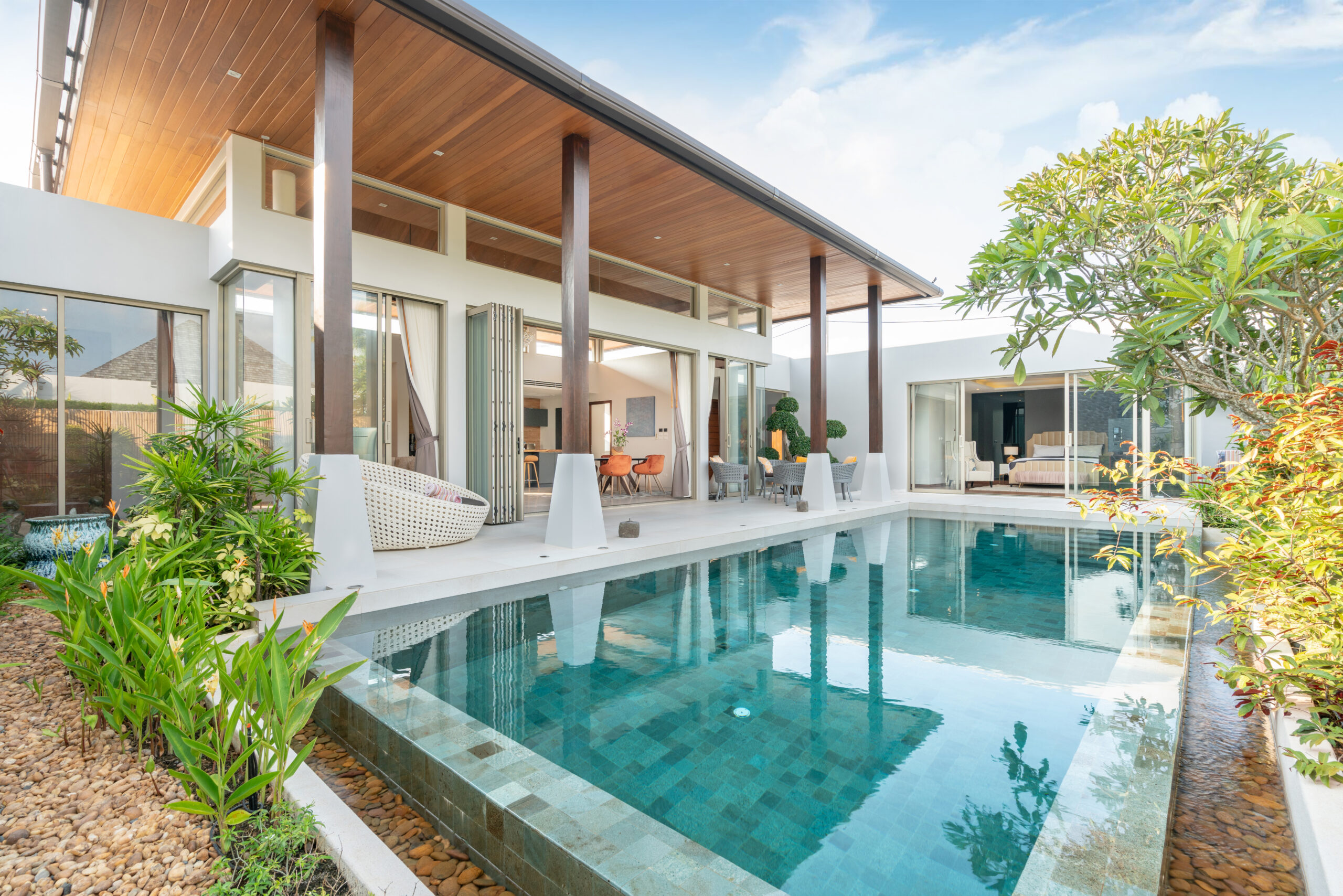 home or house building exterior and interior design showing tropical pool villa with green garden